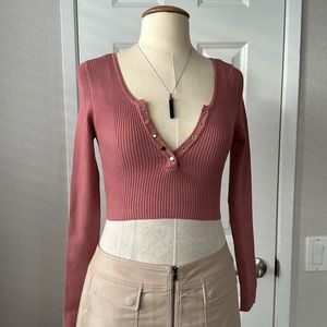 Stitchic cropped long sleeve v neck sweater with button front.